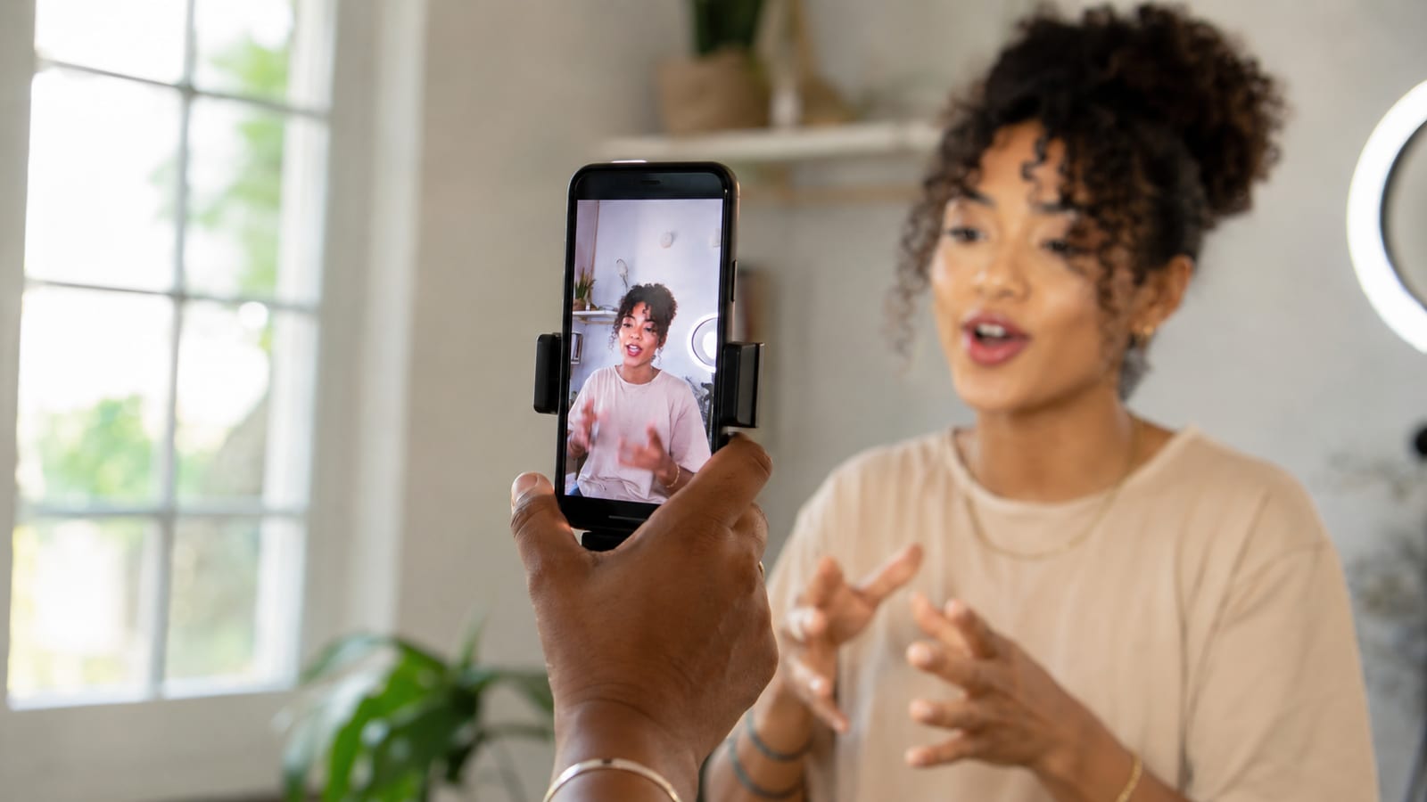 A creator filming a vertical video on a phone, a YouTube Shorts timer visible on screen